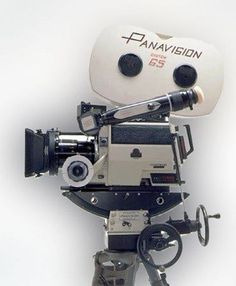 an old fashioned movie camera on a tripod with the lens attached to it's head