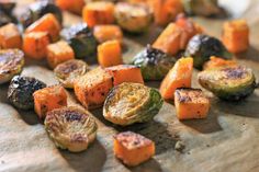 roasted brussel sprouts and carrots on a cutting board with seasoning