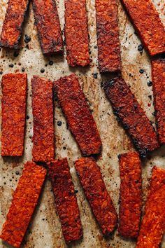 several strips of cooked meat on a baking sheet