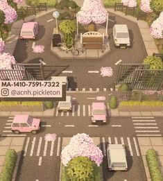 an aerial view of a parking lot with cars and flowers on the trees in bloom