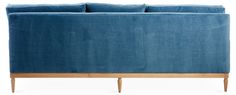 a blue couch sitting on top of a wooden frame