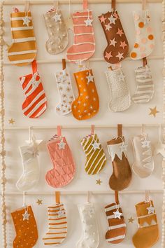 christmas stockings hanging from strings on a wall