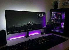 a desktop computer sitting on top of a desk next to a keyboard and monitor with the time displayed