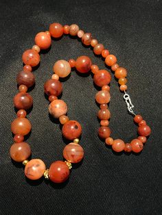 A beautiful 900 years old Pre Ankur carnelian beads necklace from Cambodia, worn by royals at that time as a luck charm. agate beads as counters. In great condition and colors of the beads are exceptional with great shine on its surface as its been continuesly used since then till now. Carnelian Gemstone Round Beads, Carnelian Round Beads, Round Carnelian Beads For Jewelry Making, Carnelian Gemstone Beads Necklace, Polished Round Carnelian Beads, Gems, And Cabochons, Carnelian Gemstone Beaded Necklaces, Natural Carnelian Round Beads Gemstones, Carnelian Beaded Necklaces With Gemstone Beads, Carnelian Polished Beads Necklace