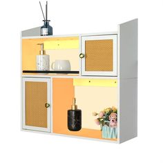 a white cabinet with yellow and orange panels on the front, black shelf below it