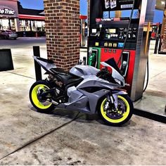 a motorcycle parked next to a gas pump