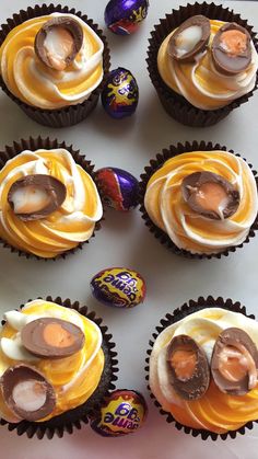 chocolate cupcakes with white frosting and decorated eggs