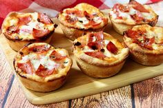 mini pizzas are arranged on a cutting board