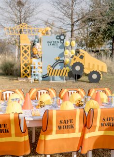 there is a table set up with safety work signs on it and construction themed decorations