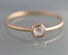 a close up of a ring with a stone in it's center on a gray surface