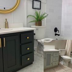 a bathroom with a toilet, sink and bathtub next to a mirror on the wall