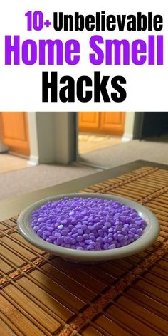 a bowl filled with purple rocks sitting on top of a bamboo mat next to a door