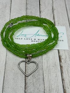 Looking for a stunning accessory that not only enhances your beauty but also symbolizes growth and renewal? 🌿 Look no further than our handmade Green Waist Beads with an open heart charm! ❤️ Crafted with high-quality glass and crystal beads, these waist beads are not only stylish but also meaningful. The color green represents growth, renewal, harmony, balance, and nature, making it the perfect way to symbolize life, renewal, and energy. The open heart charm adds a touch of elegance and beauty, Adjustable Green Heart-shaped Beaded Bracelets, Adjustable Hand-strung Heart-shaped Jewelry, Handmade Flexible Jewelry For Gifts, Handmade Heart-shaped Jewelry For Meditation, Handmade Green Heart Beaded Bracelets, Hand-strung Heart Jewelry As Gift, Hand-strung Heart Jewelry For Gift, Hand-strung Heart Shaped Jewelry For Gift, Handmade Green Heart-shaped Beaded Bracelets