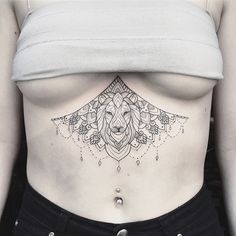 a woman with a lion tattoo on her stomach