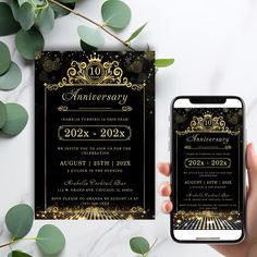 a person holding an iphone next to a black and gold anniversary party card