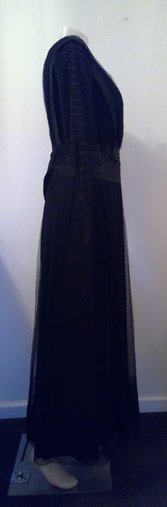 "A most amazing dress ! Edwardian mourning gown. Black silk underneath with top layer of black dotted mesh and trim pieces. Bodice interior is muslin with boning. Closes up in the back with hook and eyes, snaps on the skirt layers. Sash that hangs down the front and back with dangling acorns, one acorn needs repair. Alot if not all of this dress is hand sewn. Sleeves are amazing ! Double layer of mesh. Top layer is sewn in tiers with little satin covered buttons all the way down, decorative, the Victorian Dress With Lace Trim For Evening, Victorian Evening Dress With Lace Trim, Black Gothic Victorian Dress For Evening, Victorian Style Black Evening Dress, Regency Style Black Evening Dress, Black Regency Style Evening Dress, Black Victorian Evening Dress, Elegant Floor-length Victorian Dress For Theater, Black Victorian Dress With Lace Trim For Evening