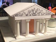 a model of a building with columns and people on it