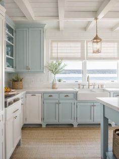 a kitchen with blue cabinets and white counter tops