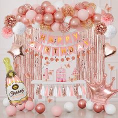 a pink and gold birthday party with balloons, streamers, confetti garlands and decorations