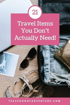 an open suitcase with shoes, sunglasses and a purse next to it that says 21 travel items you don't actually need