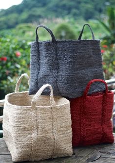 three bags sitting on top of a wooden table