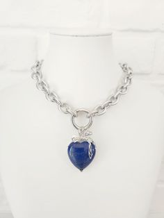 Thick Texturized Chain Stainless Steel Necklace with Lapis Lazuli Heart Pendant This stunning chunky charm necklace is the perfect statement piece. This necklace exudes elegance and style and features a large, beautifully crafted Lapis Lazuli heart pendant. The thick, texturized stainless steel chain adds a modern touch, ensuring durability and a sleek finish. Key Features: Material: High-quality stainless steel chain Pendant: Large Lapis Lazuli heart Design: Chunky, texturized chain with a big Chunky Chain Pendant Jewelry Gift, Gift Chunky Chain Necklace With Round Pendant, Sterling Silver Pendant With Chunky Chain, Chunky Chain Heart Pendant Necklace As Gift, Chunky Chain Heart Pendant Necklace For Gift, Gift Chunky Chain Stainless Steel Jewelry, Chunky Chain Heart Pendant Jewelry Gift, Silver Heart Necklace With Chunky Chain For Gifts, Gift Stainless Steel Necklaces With Chunky Chain