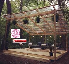 a covered patio with potted plants and lights on the roof is surrounded by trees