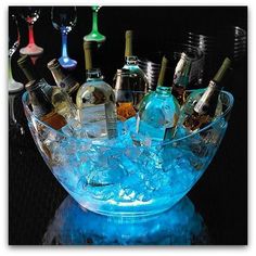 a glass bowl filled with lots of bottles