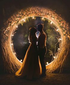 two people standing in front of a circular light