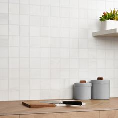 the kitchen counter is clean and ready to be used as a utensil holder