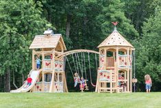 children playing on a wooden play set in the park