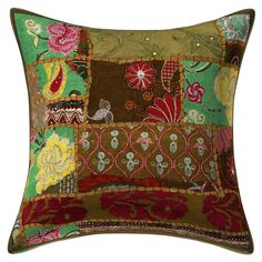 a green and red patchwork pillow on a white background