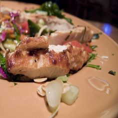 a close up of a plate of food with meat and veggies on it