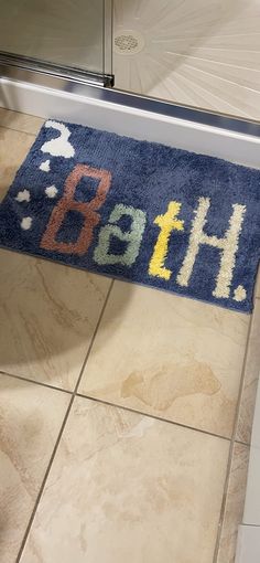 a bathroom rug with the word bath on it