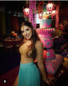 a woman standing in front of a large cake