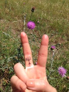 a person's hand with a small tattoo on it