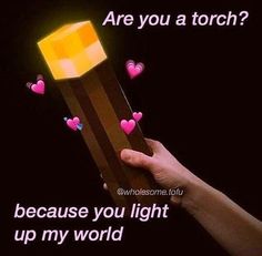 someone is holding a box with hearts coming out of it that says, are you a torch? because you light up my world