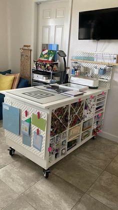 a kitchen island with lots of magnets and papers on the top, sitting in front of a door