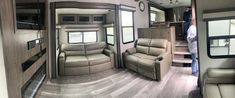 the inside of a travel trailer with two couches and a kitchen area in it