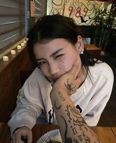 a woman sitting at a table with food in front of her