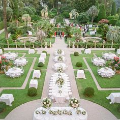 an aerial view of a formal garden setting with tables and chairs set up in the center