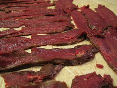 strips of meat are on a cutting board