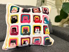 a crocheted pillow is sitting on a couch