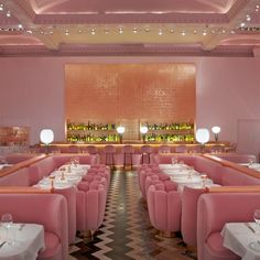 the interior of a restaurant with pink booths