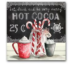 two candy canes in a glass jar next to a chalkboard sign that says hot cocoa