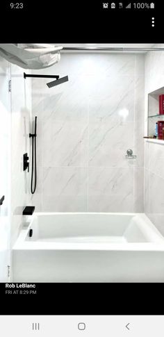 a bathroom with a white bathtub and black shower faucet next to it