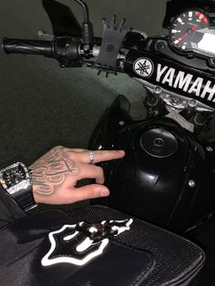 a person's hand on the handlebars of a motorcycle