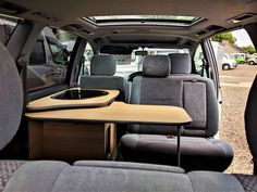 the interior of a van with a table and chairs