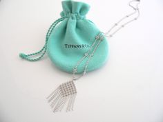 Overview:Looking for a super elegant and yet classic piece that will last a lifetime? Here it is! Offered for sale is a gorgeous Tiffany & Co. 18K White Gold Fringe / Flower Bead Dangling necklace. Great piece to wear with an open neckline shirt or dress or a dark turtleneck come winter time (but let's not think of this right now :))! The piece is almost like wearing a work of art on your neck - feminine, cosmopolitan, and very alluring. It is a wonderful necklace that fits a lifestyle on th Fringe Flower, Dangle Necklace, Gold Fringe, Dangle Necklaces, Winter Time, Cosmopolitan, Beaded Flowers, Necklace Pendant, Tiffany & Co.