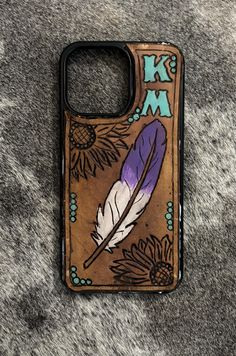 a cell phone case with an image of a feather and flowers on the back cover